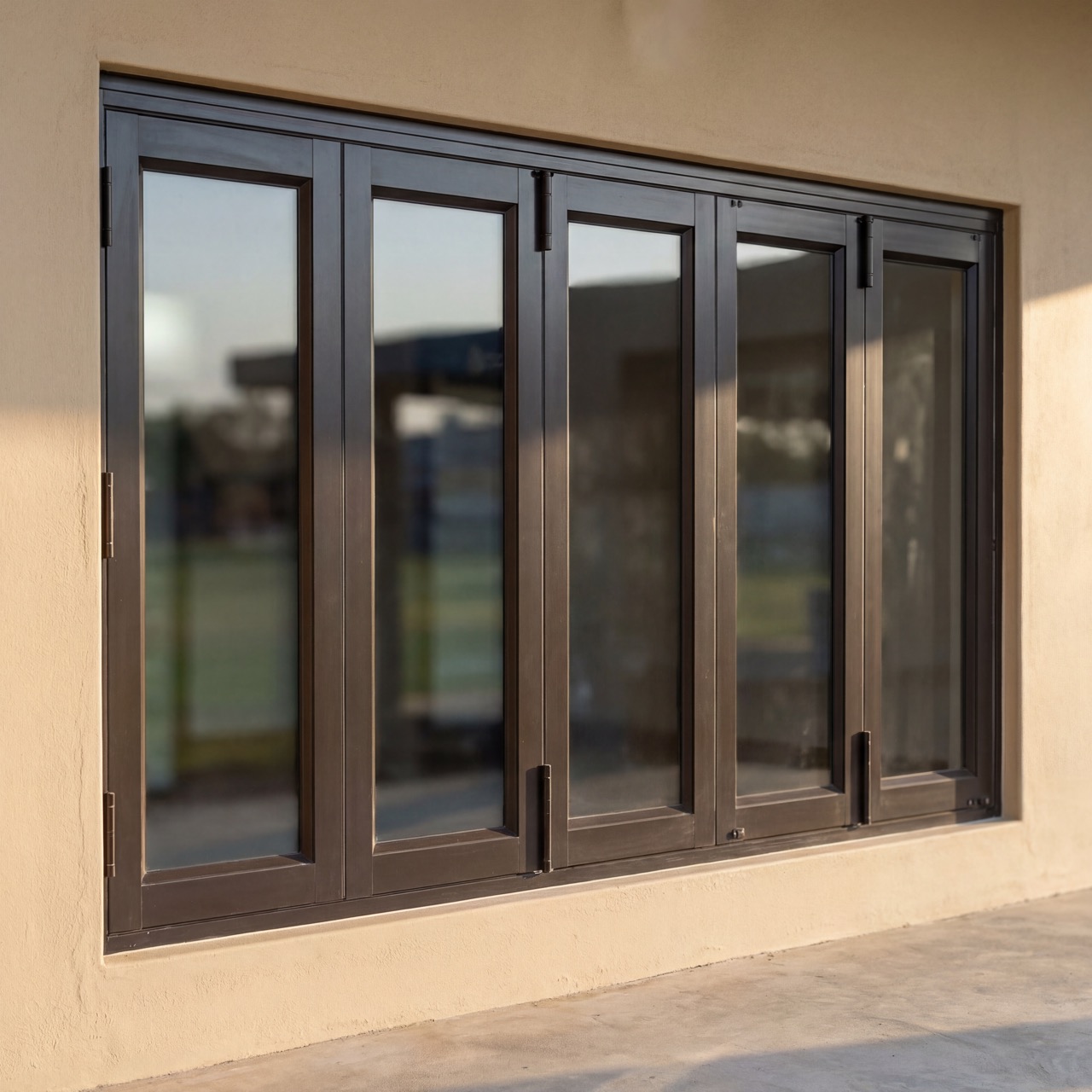Black aluminium sliding door system on a plaster exterior