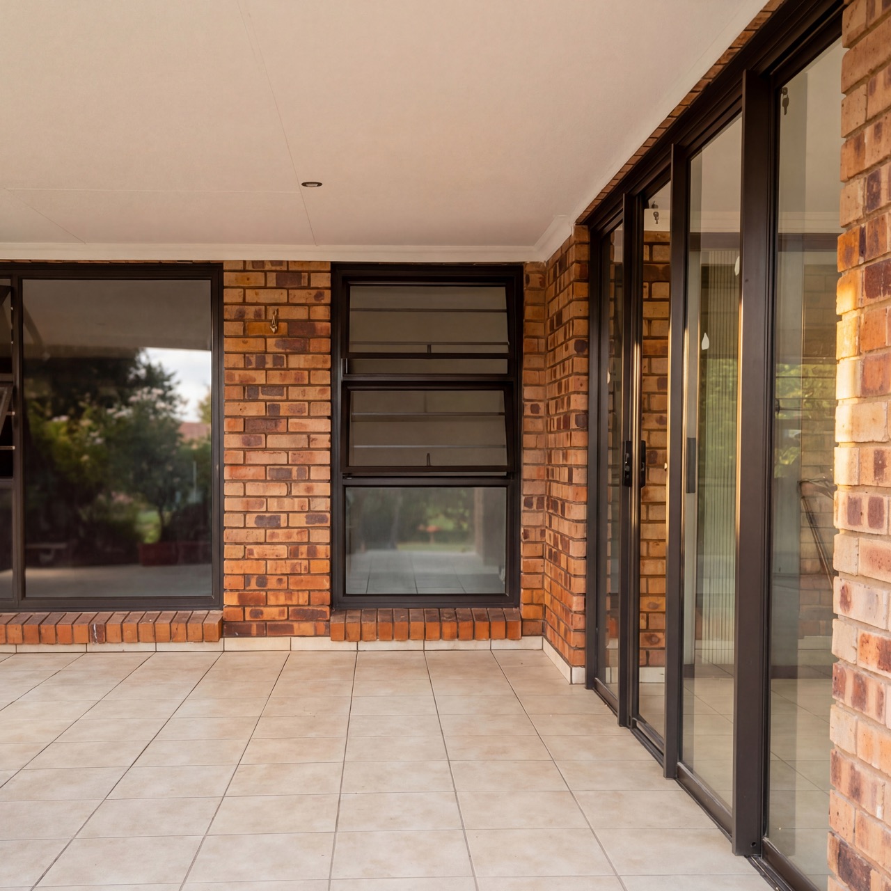 Covered patio enclosure with aluminium windows and doors