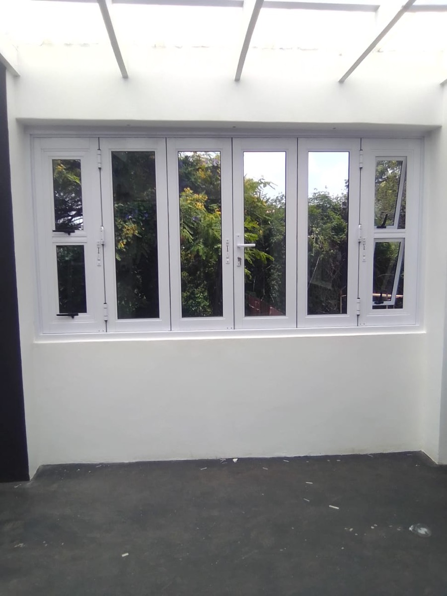 white bi-fold window system with garden view, interior shot