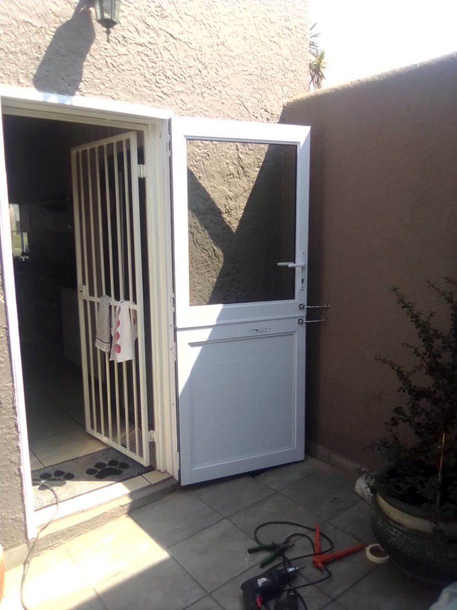 white aluminium stable door with security gate behind